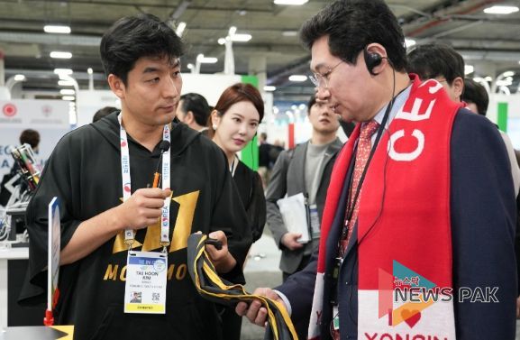 이상일 용인특례시장이 야구 투구 연습 도구 '자이로스피드'를 개발한 마고의 김태훈 대표로 부터 제품 설명을 듣고 있다.